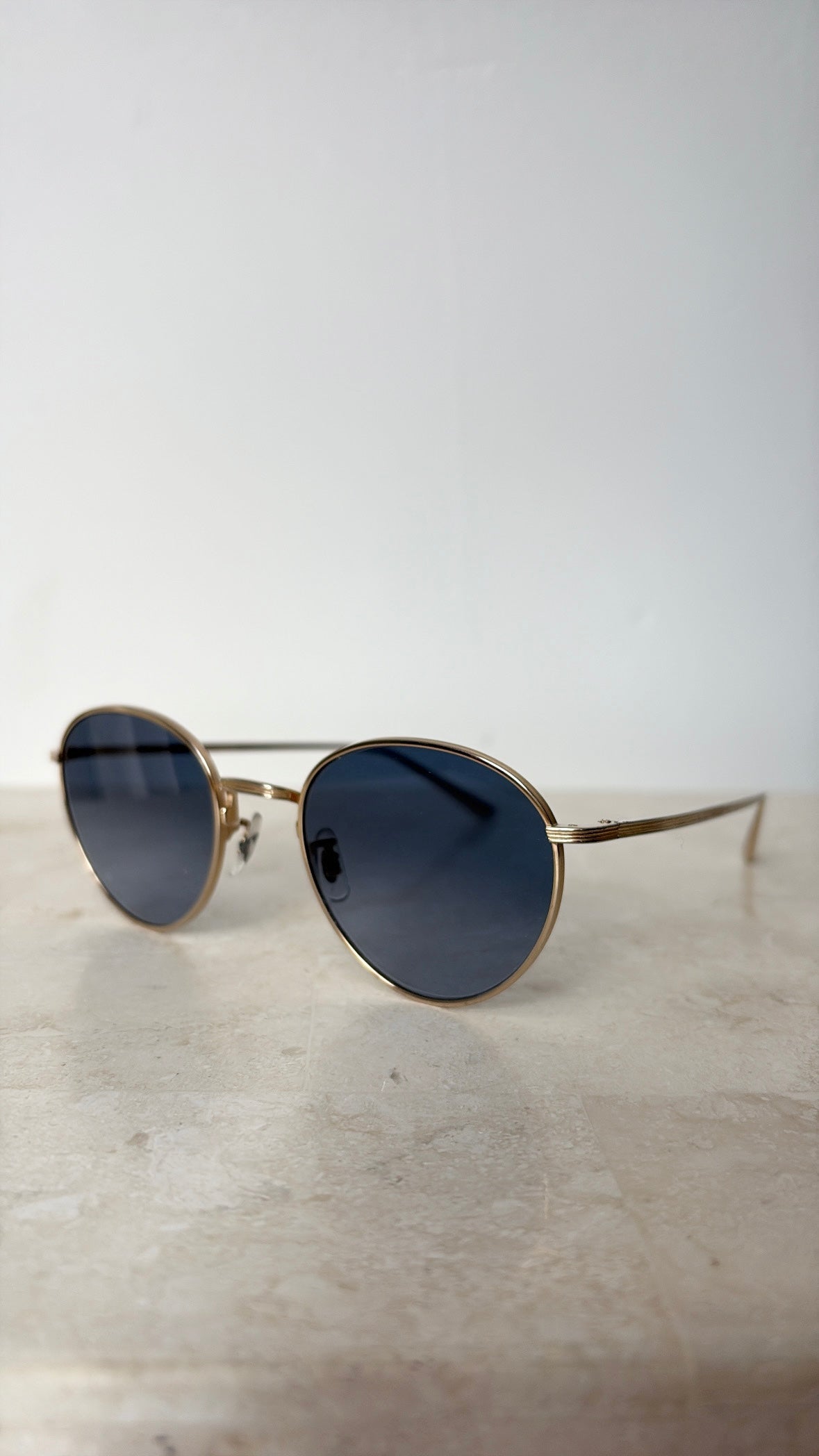 Oliver Peoples Gold Oval Sunglasses with Blue Lens