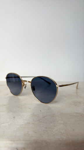 Oliver Peoples Gold Oval Sunglasses with Blue Lens