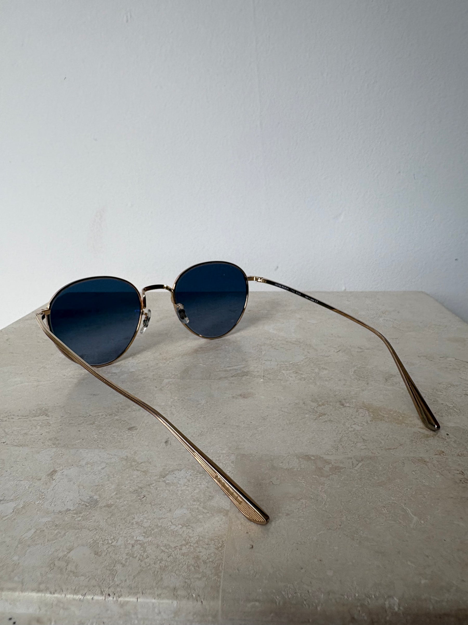 Oliver Peoples Gold Oval Sunglasses with Blue Lens