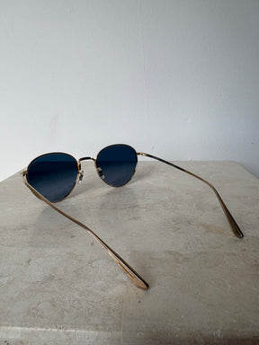 Oliver Peoples Gold Oval Sunglasses with Blue Lens