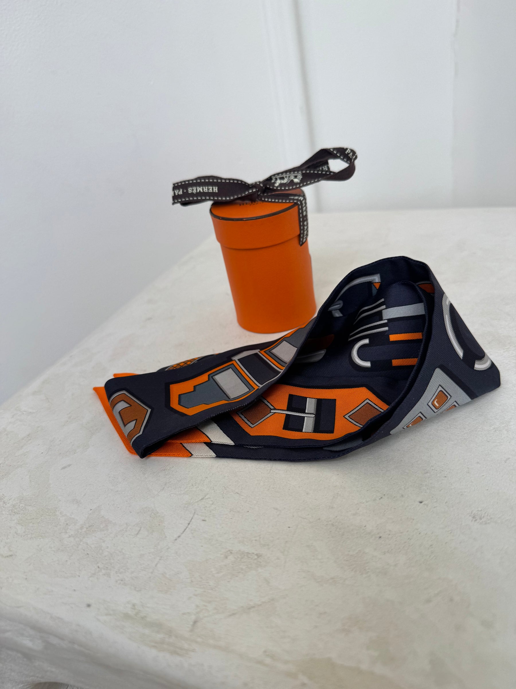 Hermès 100% Silk Navy And Orange Printed Twilly
