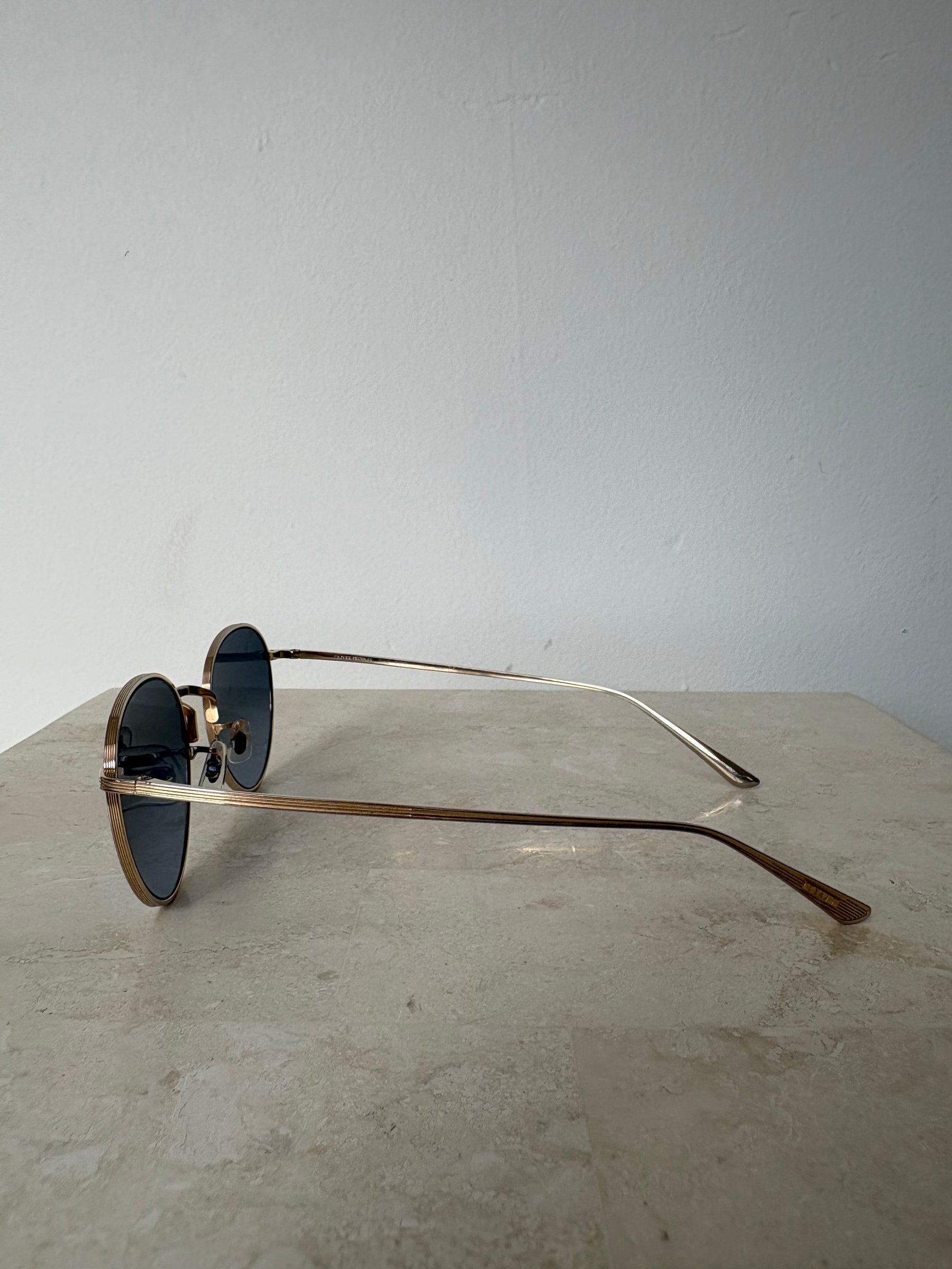 Oliver Peoples Gold Oval Sunglasses with Blue Lens