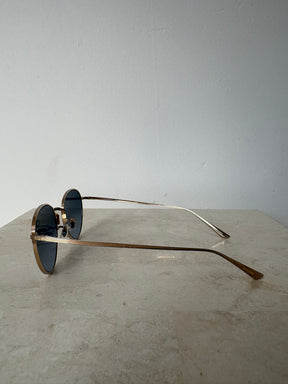 Oliver Peoples Gold Oval Sunglasses with Blue Lens