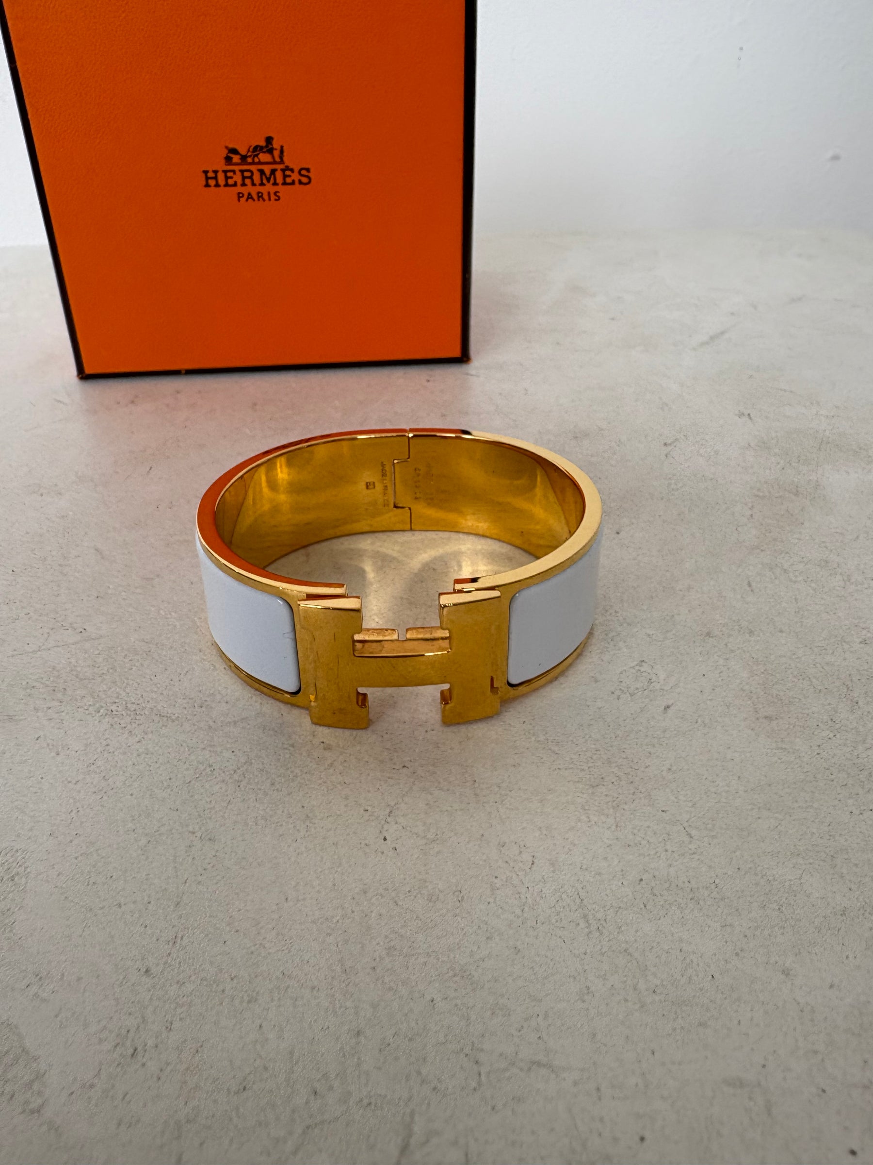 Hermès Gold Tone and White Enamel Clic Clac H Bracelet`