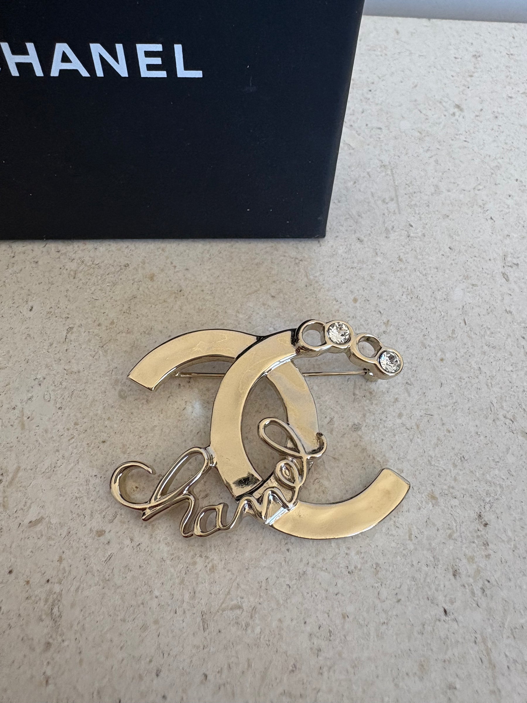 Chanel Gold Tone Logo Crystal brooch