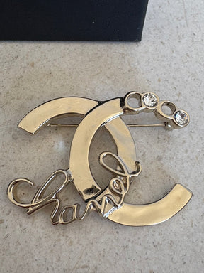 Chanel Gold Tone Logo Crystal brooch